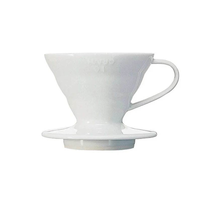 A white ceramic hario pour-over v60 coffee dripper with a matching saucer at the artisan place, doha, qatar